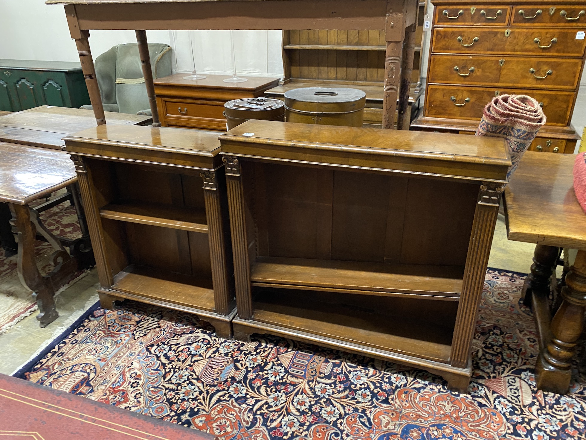 A pair of 18th century style walnut open bookcases in two sizes, larger width 104cm, depth 28cm, height 101cm